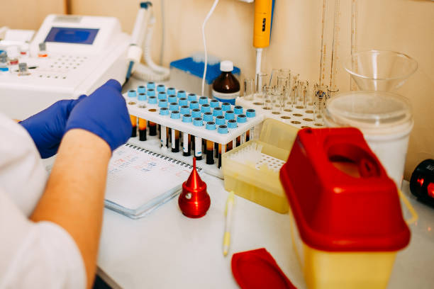 istock Blood test process in laboratory. Doctor hands making blood test. Many blood test-tubes with blood on the table. Covid-19 testing. 1214467814