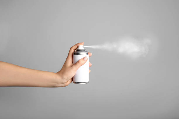 istock Female hand spraying paint can 1214471300