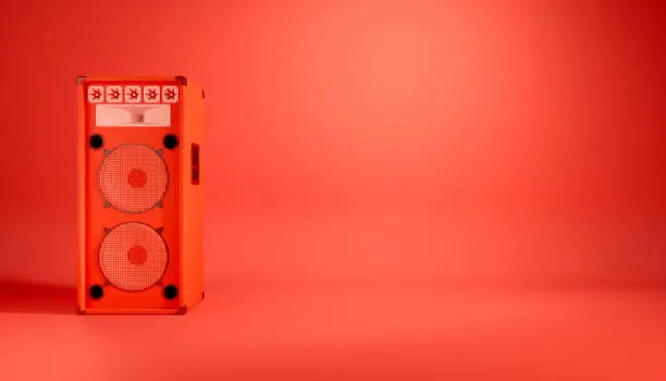 Photo of red speaker system on red background