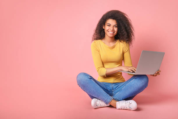istock Young african woman with laptop 1214473098