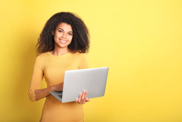 istock Young african woman with laptop 1214473139