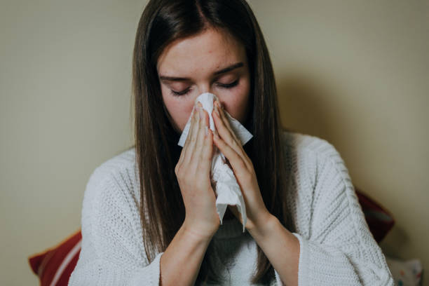 istock Woman sick in bed, covered with blanket 1214473763