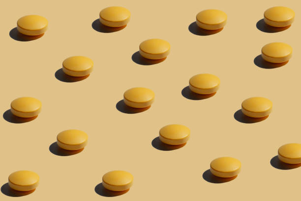 istock Yellow Pills on yellow pop art Background 1214473820