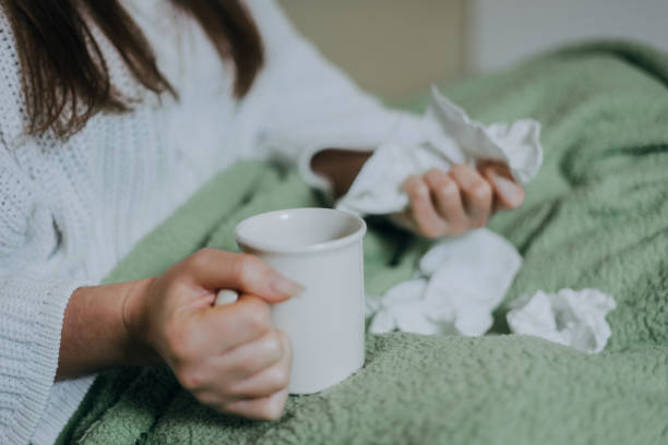 istock Woman sick in bed, covered with blanket 1214474277
