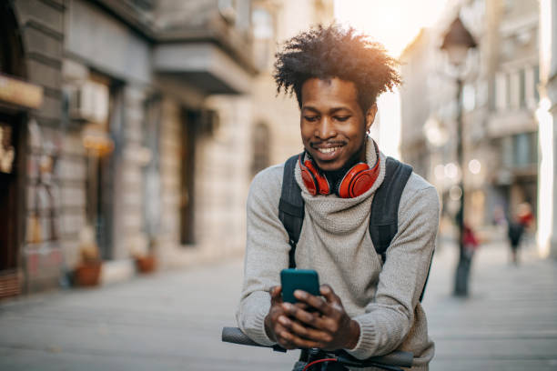 istock Young man walking and listening music 1214475964