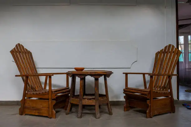 Photo of wooden chairs with a table in the yard