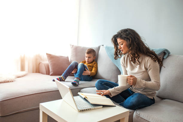 istock Millennial generation mother working from home with small children while in quarantine isolation during the Covid-19 health crisis 1214476731