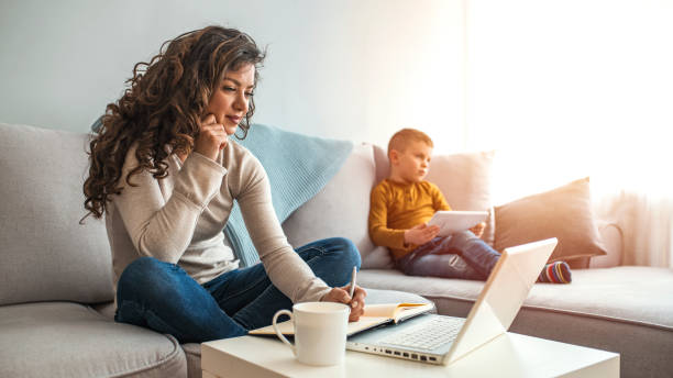 istock Busy young woman with son at home. 1214477524