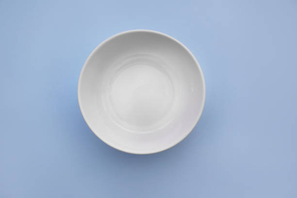 White ceramic bowl on blue background