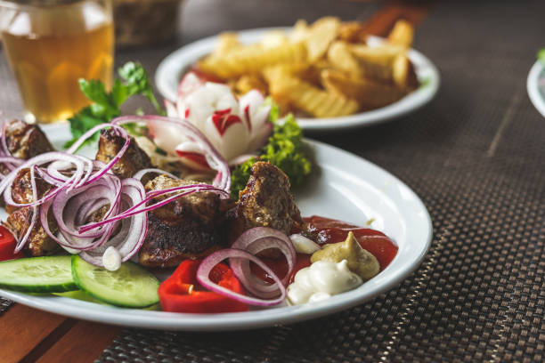Shish kebab with vegetables and french fries