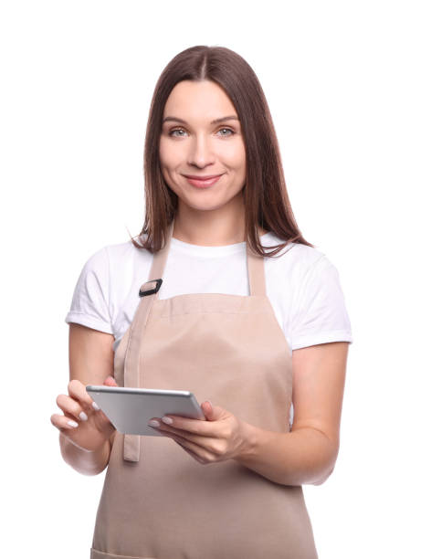 istock Young woman in apron with tablet 1214479843