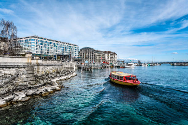 Beautiful view of Geneva skyline with famous Jet d'Eau fountain at harbor district in beautiful evening light, Switzerland.