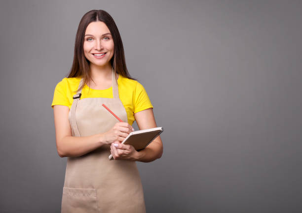 istock Young wonan waitress portrait 1214479909