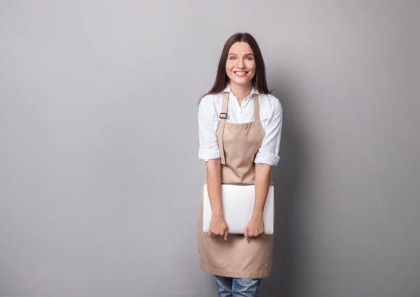 istock Young woman in apron portrait 1214480144