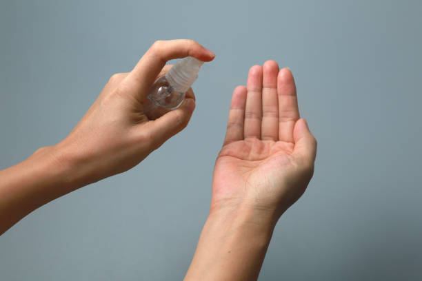 istock Woman Using Alcohol Spray Hand Sanitizer 1214481178