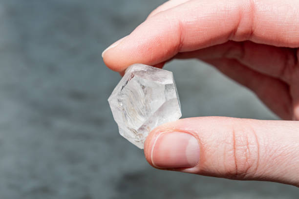 istock Raw diamond big dob between two fingers thumb and forefinger 1214481730