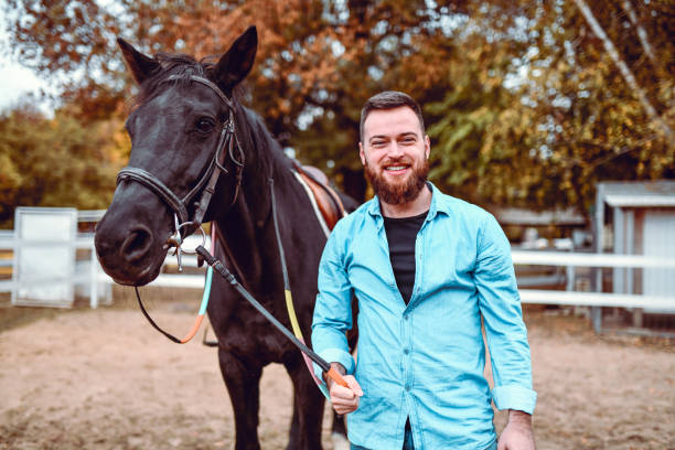 istock Handsome Male And His Black Stallion 1214481768