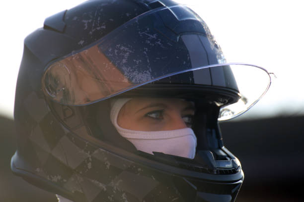 istock Female race car driver wears helmet and balaclava 1214482449