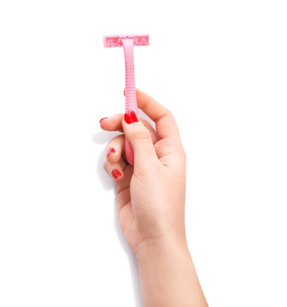 istock Female hand with pink razor 1214482725