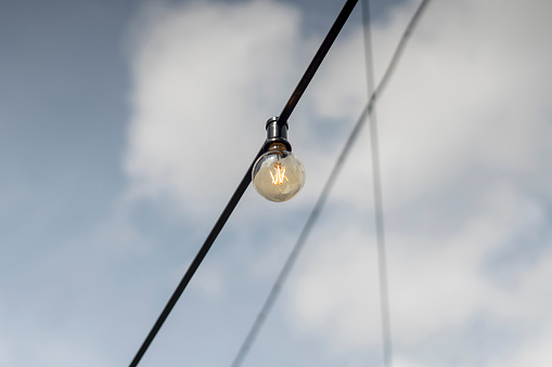 Isolated light bulb with sky background
