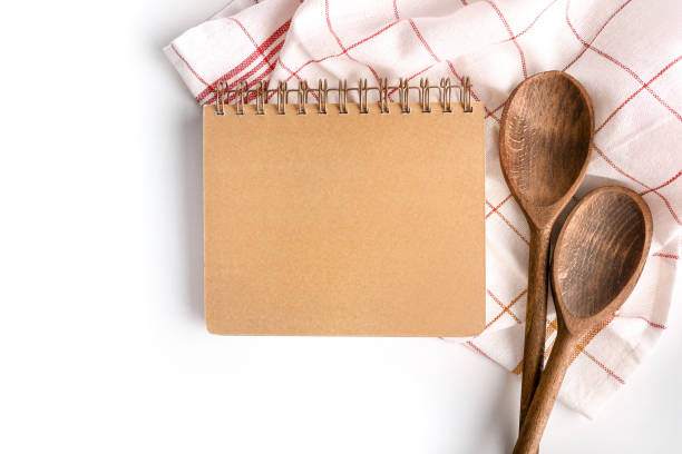 istock Recipe notebook with wooden spoons 1214483249