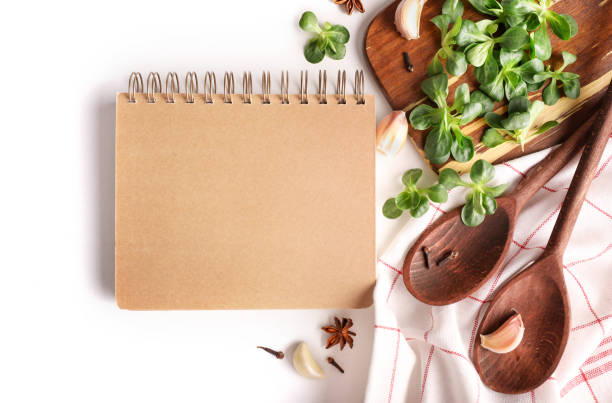 istock Recipe notebook with wooden spoons, menu background 1214483397