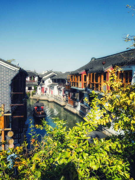 Zhujiajiao Canal Town, Shanghai, China Zhujiajiao, China - November 15 2019: Zhujiajiao is an ancient water town located in the Qingpu District of Shanghai. It is well-known throughout China and a popular getaway from Shanghai with both foreign and domestic tourists. The town has a history of more than 1700 years and is famous for the 36 bridges that cross its canals. Zhujiajiao stock pictures, royalty-free photos & images