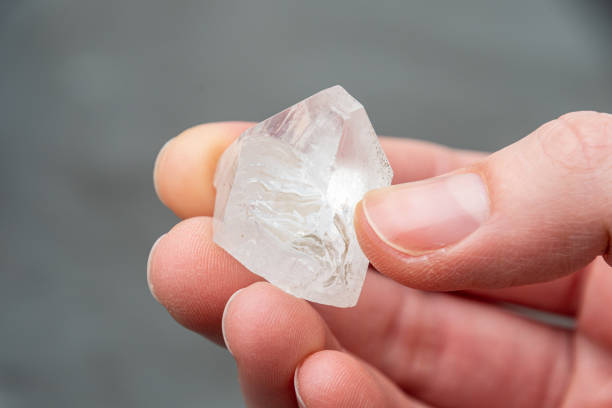 istock Raw diamond holding big dob in hand between fingers 1214484353