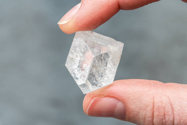 istock Raw diamond holding big dob in hand between thumb and forefinger 1214484354
