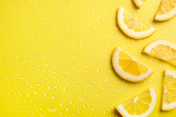 istock Fresh lemon slices on yellow background 1214486829