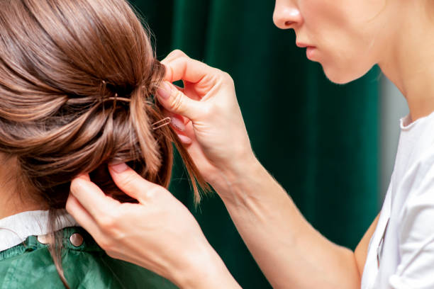 istock Hairdresser makes hairstyle. 1214487573