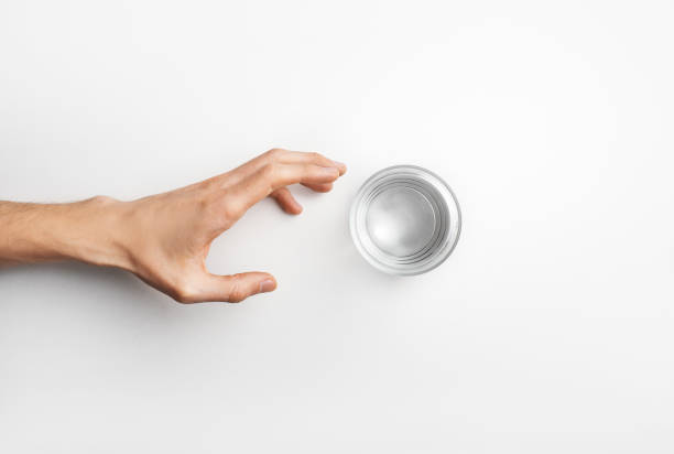 istock Hand reaching glass with water 1214488253