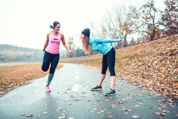 istock Athletic Females Stretching Before Going For A Run In Park 1214488341