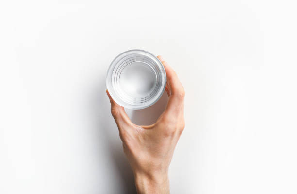 Hand holding glass of water