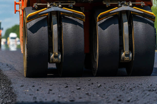 Road roller flattening new asphalt.