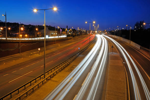 istock Long exposure wide angle view of motorway at dusk light trails 1214490236