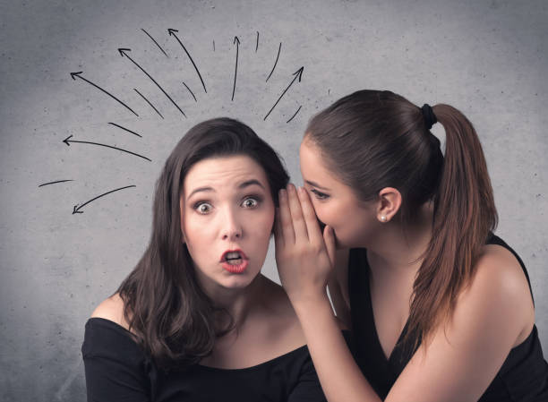 istock girl telling secret things to her girlfriend 1214490900