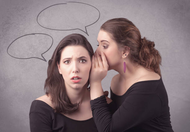 istock girl telling secret things to her girlfriend 1214491598