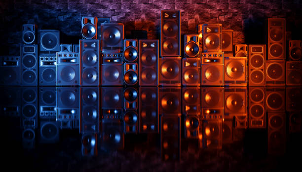 istock speaker system on a black background in blue and orange lighting 1214491710