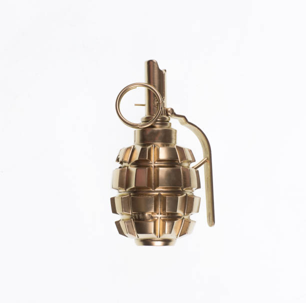 istock golden combat grenade isolated on a white background 1214492434