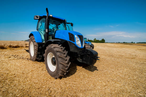 istock New blue tractor working on the field, modern agricultural transport 1214492631