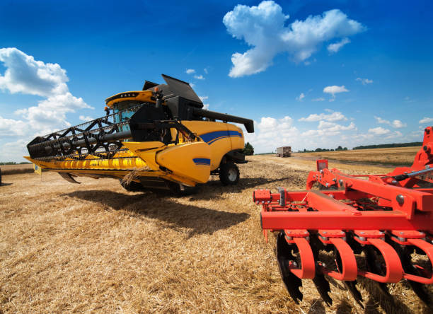 istock machinery combine harvester on stubble wheat field 1214493217