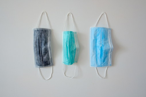Three face mask hang on the wall