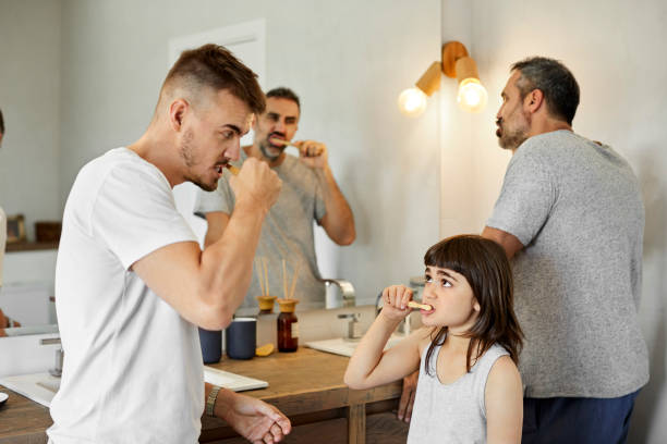 istock Family brushing teeth together in bathroom 1214494509