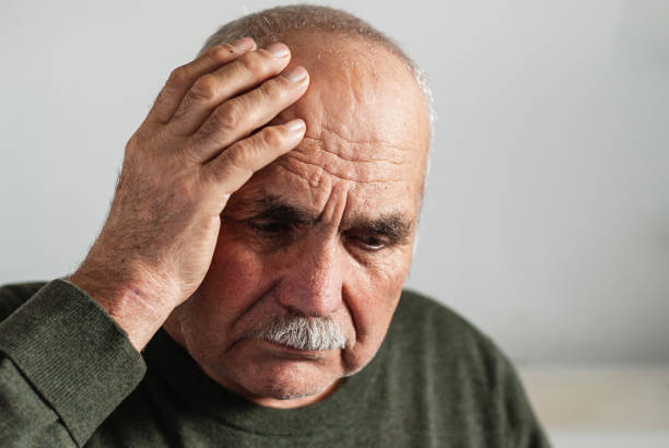 istock Forgetful senior man holding a hand to his head 1214495587