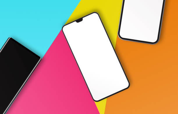 3 blank screen Smartphones on Colored Papers. Horizontal composition with copy space.