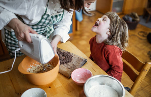 istock Toddler Boy Making cookies with his mother 1214495866