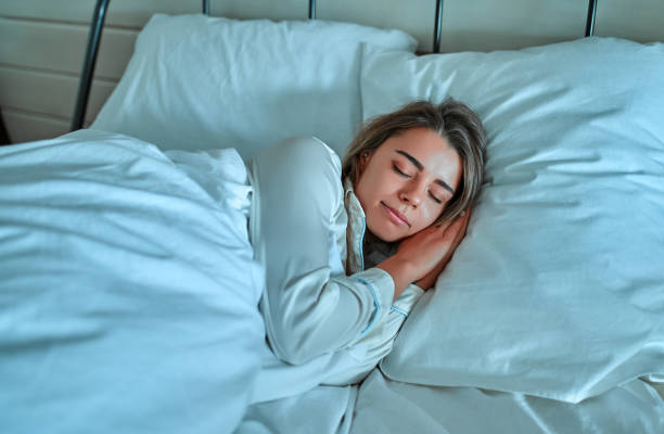 istock Woman in pajamas in bed 1214497090