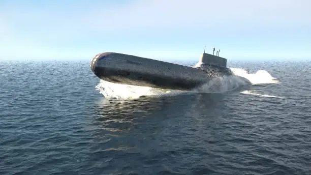 A nuclear-powered military submarine emerges from the depths of the ocean.