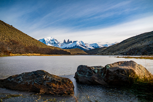 Frozen lake and Torres del Paine Mountains in Patagonia, postcard of the National park with the Cuernos de Paine